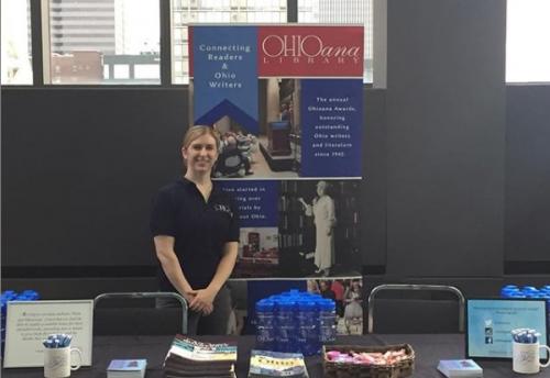 Office Manager Kathryn Powers in front of Ohioana's table at Books by the Banks.